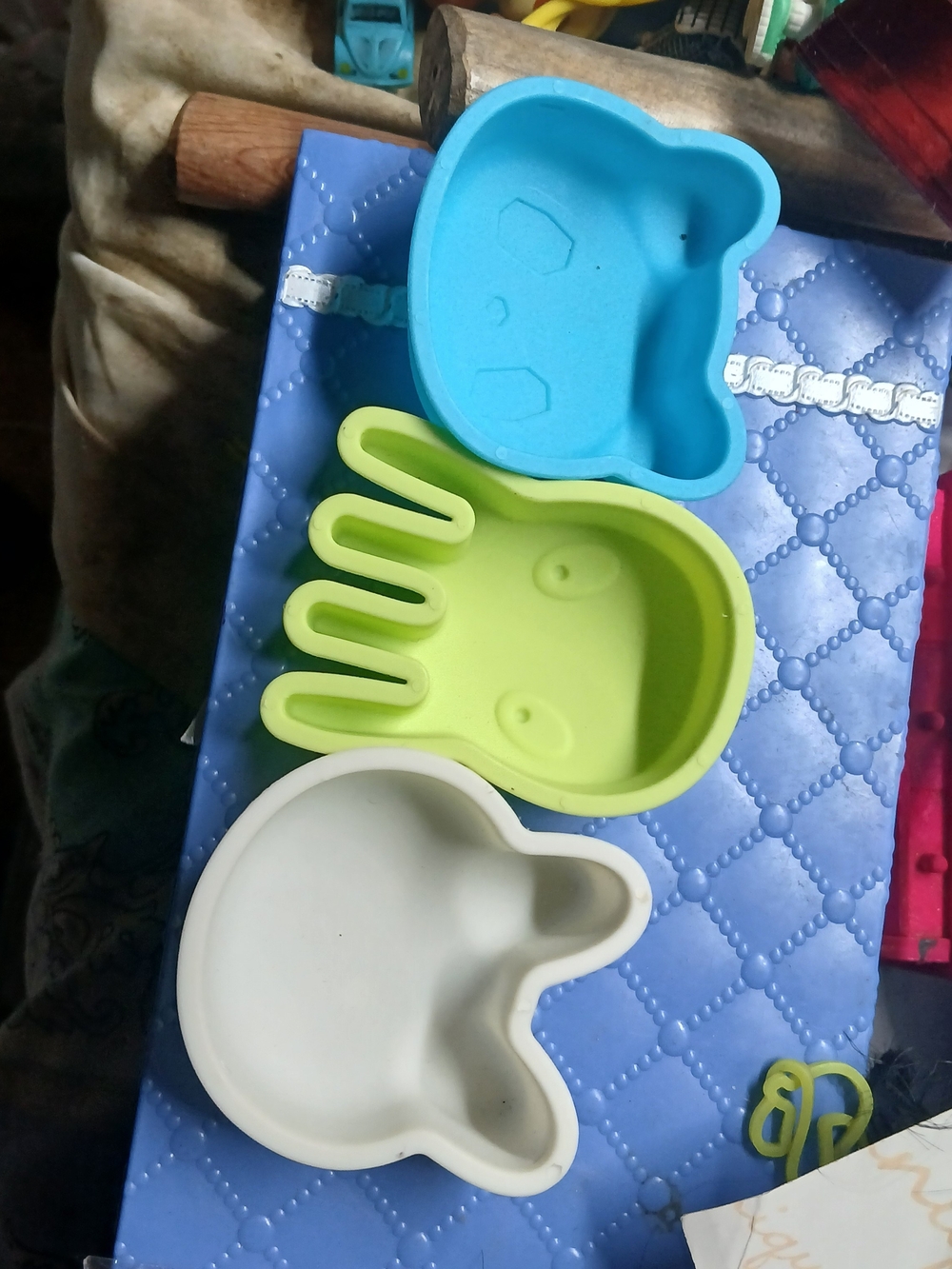 three animal-shaped silicone molds or containers Blue,green, White